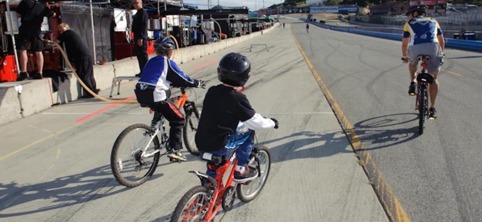 image of twilight kids and adult cycling the race track