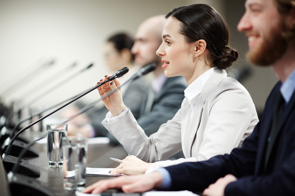 image of woman speaking into a microphone