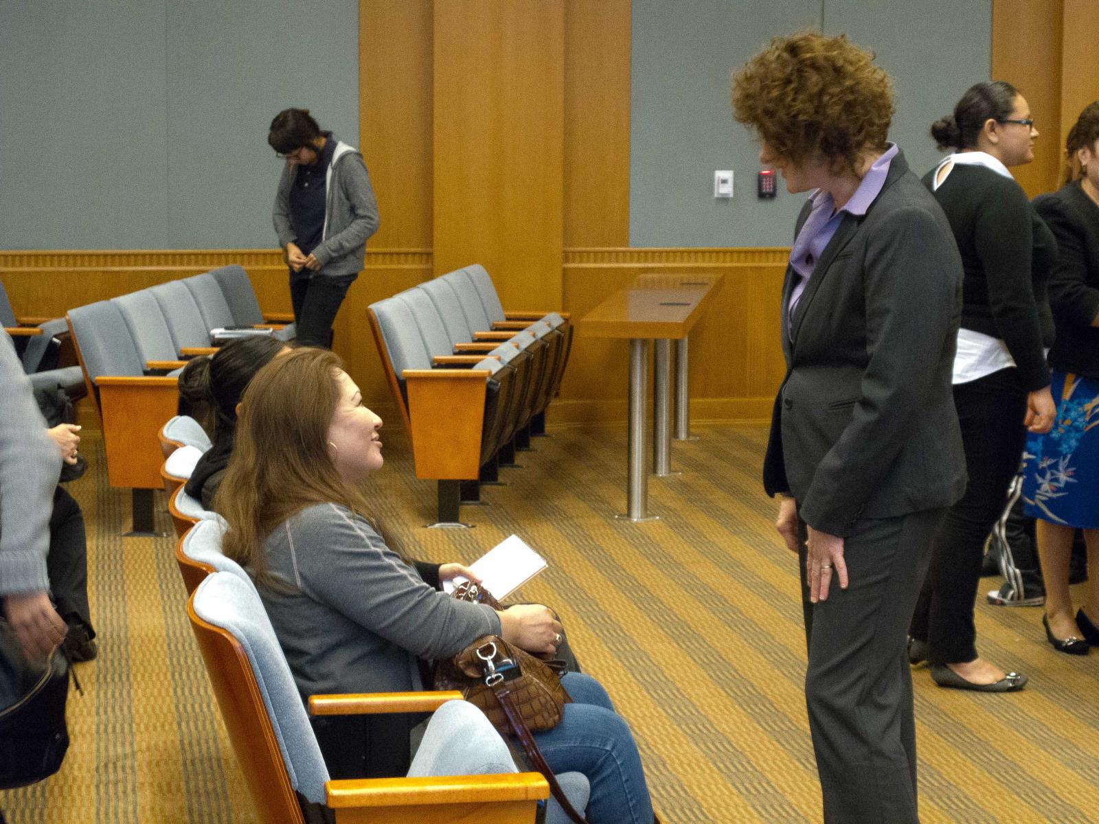 two adult females speaking