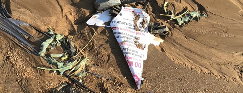 Bad post example: Sign has fallen next to crop field