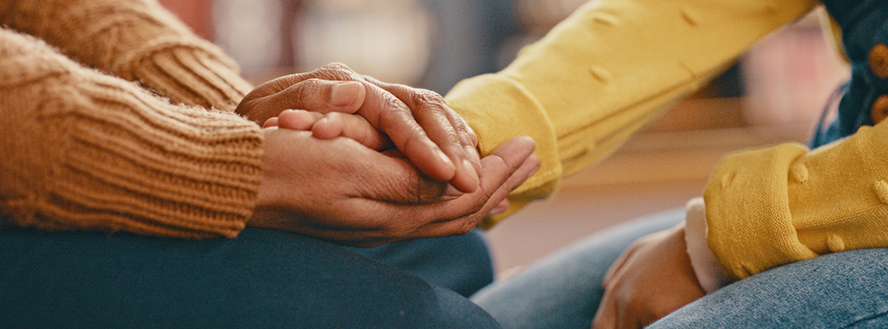 panoramic photo of person both in seating positions holding another persons hand