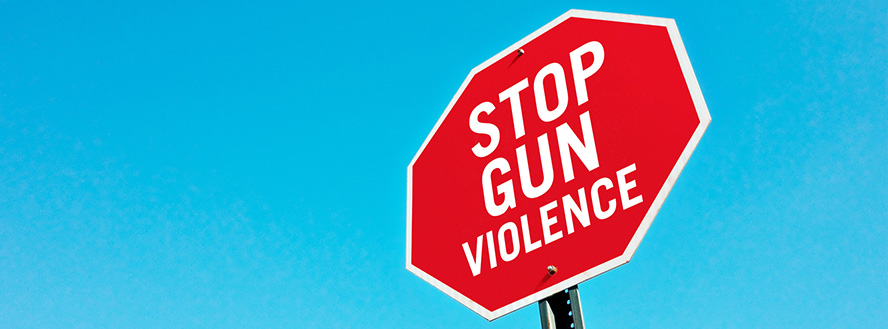 photo of a stop sign displaying the words stop gun violence