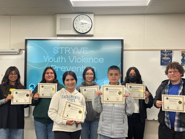 Group of teens with certificates