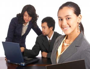 Manager standing while staff are working