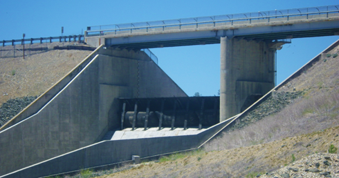 photo of raised rubber dam as seen from front of spillway