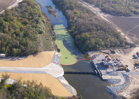 photo of rubber dam inflated and Pump Station in final stages of construction